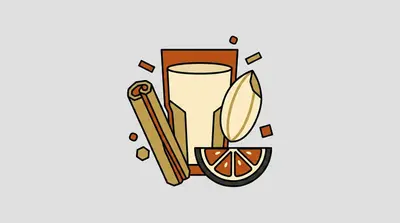 A tall glass of pale liquid, a rolled spice stick, an oval seed, and a halved citrus wedge with visible seeds.