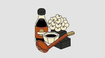 A bottle and bowl of soy sauce alongside a pile of soybeans and a wooden ladle.