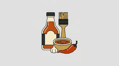 A bottle of hot sauce, a basting brush, a bowl of sauce, a garlic clove, and a red chili pepper.