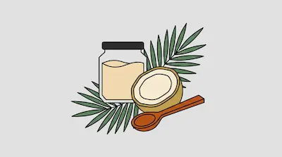 A jar of coconut oil, a halved coconut, and a wooden spoon set against green palm leaves.