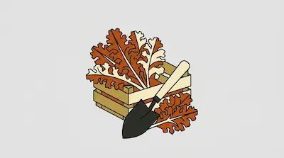 A garden shovel leans against a wooden crate filled with large, lobed orange and cream leaves.