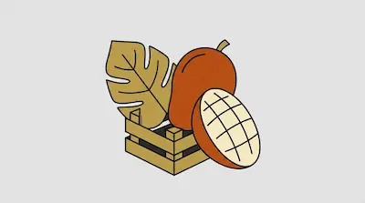 A whole mango, a sliced mango half, and a large tropical leaf are arranged with a small wooden crate.
