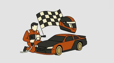A pit crew member kneels by an orange and black race car next to a checkered flag and a racing helmet.