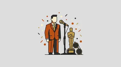 A man in an orange suit beside a microphone, a golden award statuette, and a pair of round sunglasses.