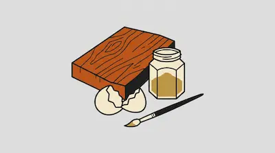 A wooden block, a jar of yellow pigment, a cracked eggshell, and a paintbrush.