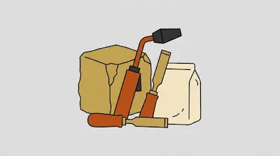 A block of stone, a bag of material, and several carving tools including chisels and a mallet.