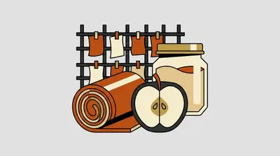 A rolled fruit strip, a halved apple, a jar of puree, and sheets clipped to a drying rack.