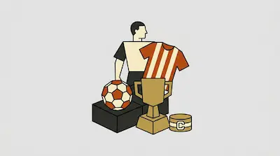 A man stands behind a soccer ball, a trophy, a striped jersey, and a captain's armband.