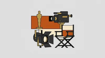 A gold award statue, a movie camera, a director's chair, and a studio light are grouped together.