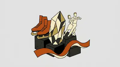 Orange ice skates, a large faceted crystal, and a dancing couple are arranged on dark blocks with a flowing red ribbon.