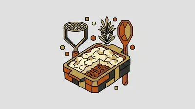 A baking dish filled with a layered casserole, a potato masher, a sprig of herbs, and a wooden spoon.