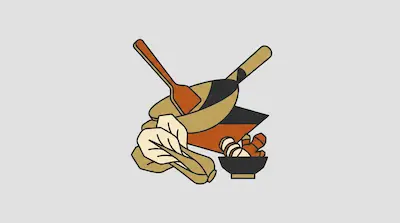 A wok and spatula are arranged with a head of bok choy and a small bowl of ginger.
