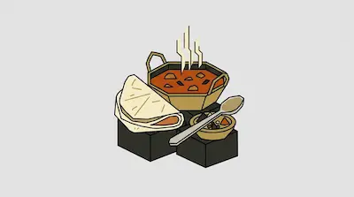 A bowl of steaming curry, a piece of flatbread, and a small side dish with a spoon.