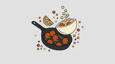 A frying pan with several round balls inside, a bowl of small beans spilling over, and a lemon wedge.